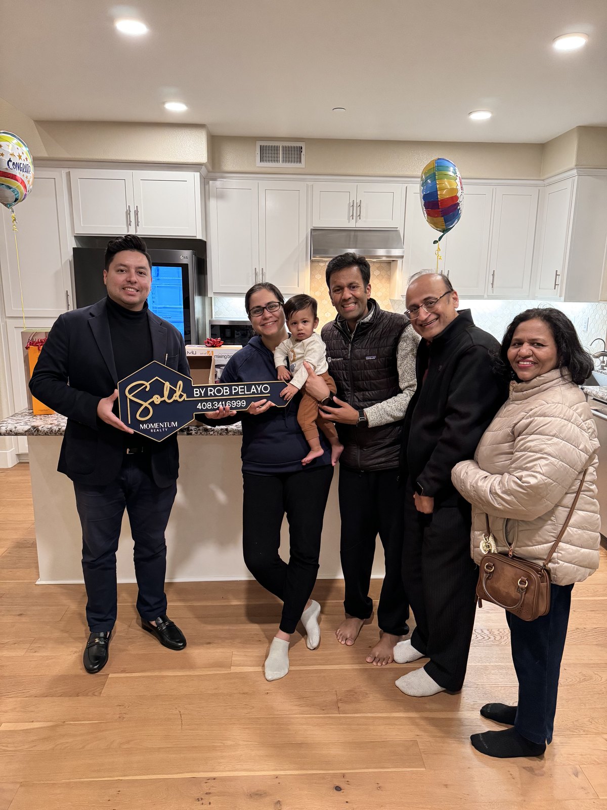 Happy buyers holding the keys to their new home